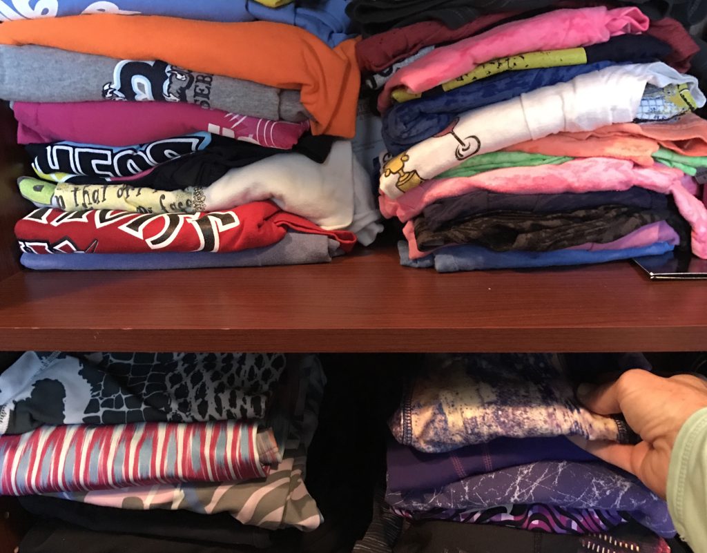 shelves of shirts in a closet 2021 09 01 06 03 53 utc