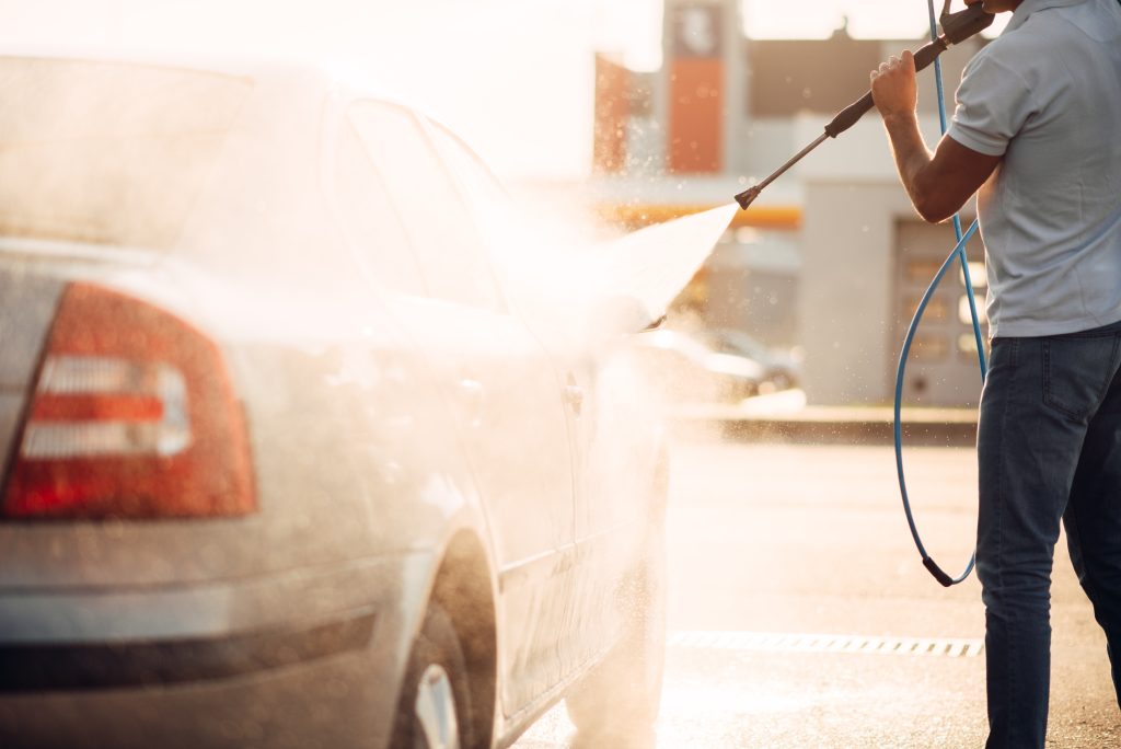 male worker wash the car with high pressure washer 2021 08 26 16 25 47 utc