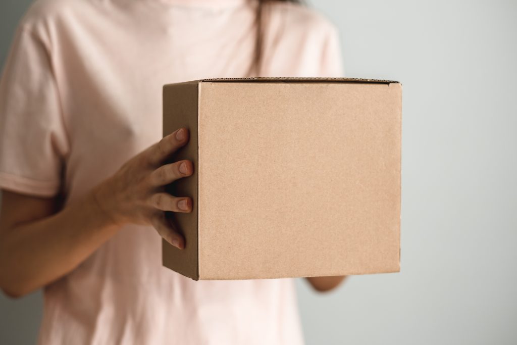 woman holding a cardboard box the parcel in hands 2022 12 22 03 32 11 utc