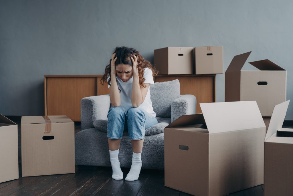 tired european woman sitting among packed boxes h 2022 04 25 14 38 03 utc