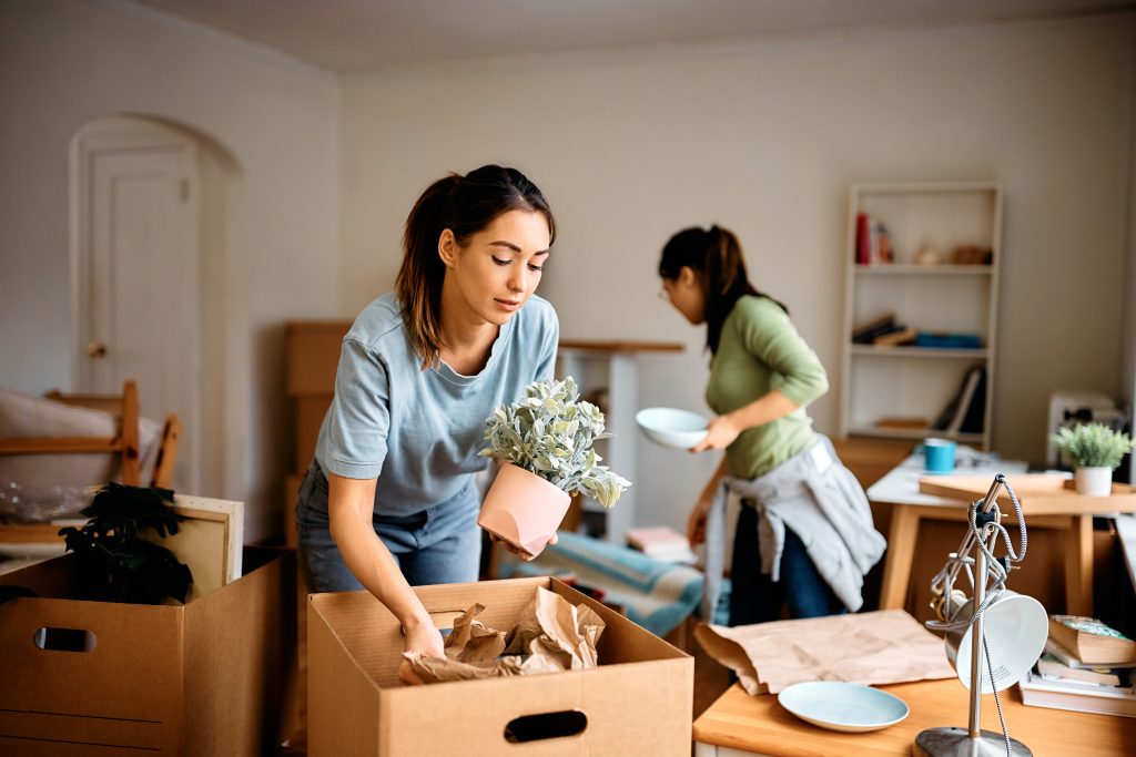 young woman and her friend packing their belonging 2023 04 17 22 29 54 utc