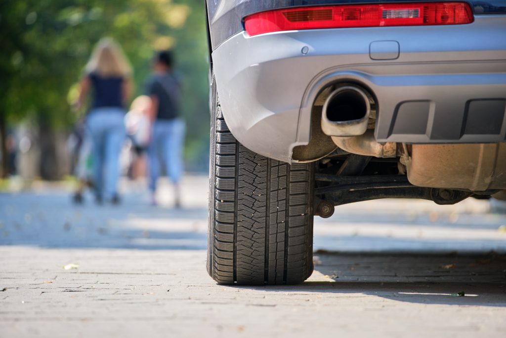 close up of car rear wheel and exhaust pipe parked 2022 03 30 00 21 54 utc